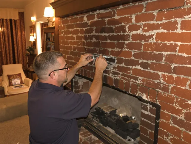 Upper Arlington Chimney Sweep expert fixing a fireplace in Upper Arlington, OH
